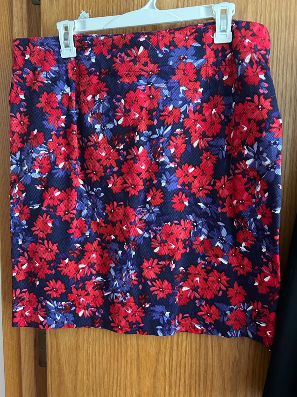 4 ladies woman’s skirts. Floral, black & navy. Size 12 large. Like new.